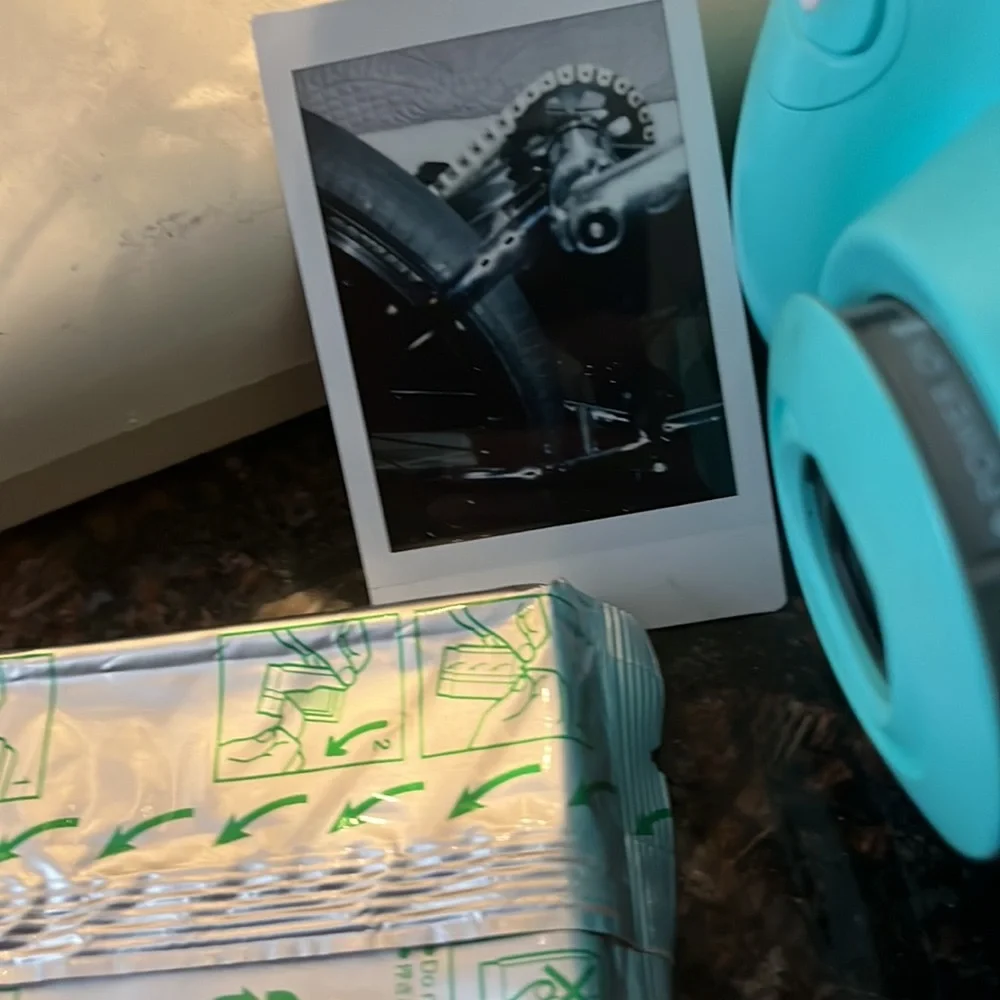 Polaroid camera made by Fujifilm called the Instax mini 7s